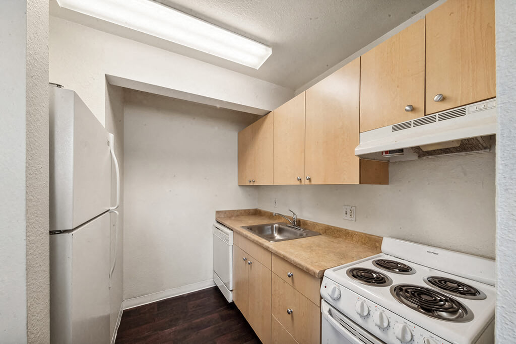 A bright, white kitchen at The Pines Apartments in Denver, Colorado.